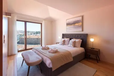 a living room with a blue couch and a tv at Porto Riverviews | Monte dos Judeus in Porto