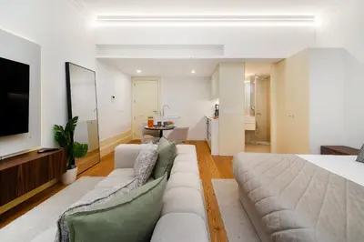 a living room with a couch and a television at WHome Modern Studio in Santa Catarina in Porto