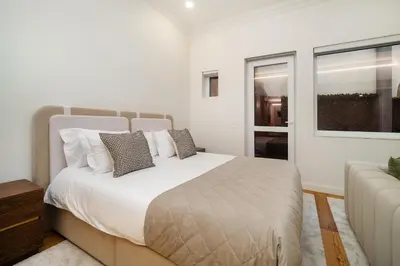 a white bedroom with a bed and a window at WHome Modern Studio in Santa Catarina in Porto