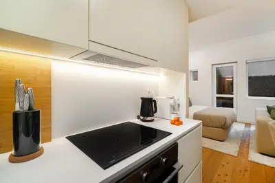 a kitchen with a counter top and a living room at WHome Modern Studio in Santa Catarina in Porto