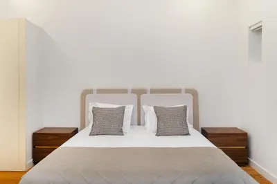 a white bed with two night stands and two pillows at WHome Modern Studio in Santa Catarina in Porto