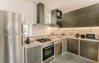 a kitchen with stainless steel appliances and a refrigerator at Oporto Welcome Apartments - Ribeira Negra in Porto