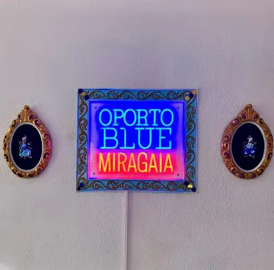 a room with a table and chairs and a purple light at Oporto Blue Miragaia - Central Apartment With Charm in Porto