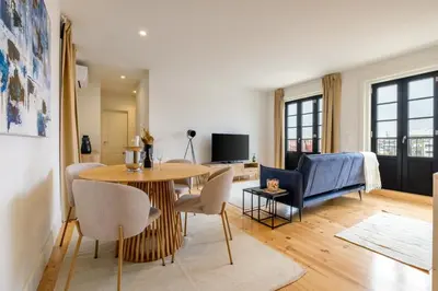 a living room with a table and chairs at Art Deco 42 Luxury 2BR Apartment Downtown Metro AC in Porto