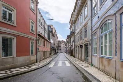an empty street in an alley with buildings at Art Deco 42 Luxury 2BR Apartment Downtown Metro AC in Porto