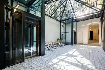 an internal view of a building with glass doors and a patio at Art Deco 42 Luxury 2BR Apartment Downtown Metro AC in Porto