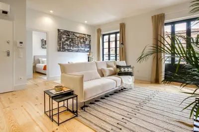 a living room with a couch and a table at Art Deco 23 Luxury 2BR Apartment Downtown Metro AC in Porto