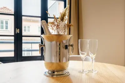 a blender sitting on a table with two wine glasses at Art Deco 23 Luxury 2BR Apartment Downtown Metro AC in Porto