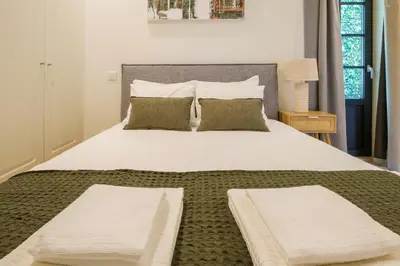 a bedroom with a large white bed with two pillows at Art Deco 23 Luxury 2BR Apartment Downtown Metro AC in Porto