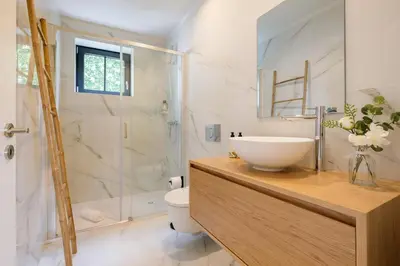 a bathroom with a sink and a toilet and a shower at Art Deco 33 Luxury 2BR Apartment Downtown Metro AC in Porto