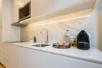 a kitchen counter top with a sink and a sink at Art Deco 12 Luxury 2BR Apartment Downtown Metro AC in Porto
