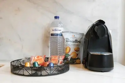 a bottle of water sitting next to a toaster at Art Deco 12 Luxury 2BR Apartment Downtown Metro AC in Porto
