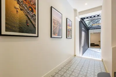 a hallway with paintings on the walls of a house at Art Deco 12 Luxury 2BR Apartment Downtown Metro AC in Porto