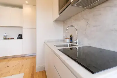 a kitchen with a sink and a counter at Art Deco 41 Luxury Apartment Downtown Metro AC in Porto