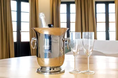 a champagne pitcher and two wine glasses on a table at Art Deco 41 Luxury Apartment Downtown Metro AC in Porto