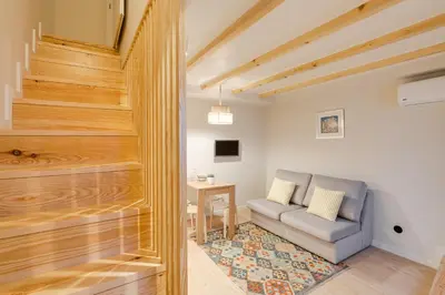 a living room with a couch and a table at Figueirôa Four Houses by DA'Home in Porto