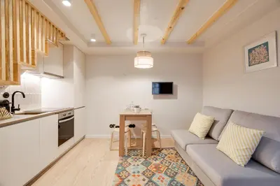 a living room with a couch and a table at Figueirôa Four Houses by DA'Home in Porto
