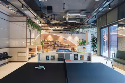 a restaurant with tables and potted plants on the wall at The Social Hub Porto Extended Stay in Porto