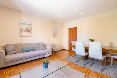 a living room with a couch and a table at Bright & Spacious Flat by Host Wise in Porto