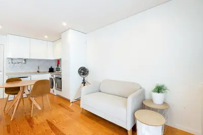 a living room with a white couch and a table at GuestReady - Homely escape near Bolhão in Porto