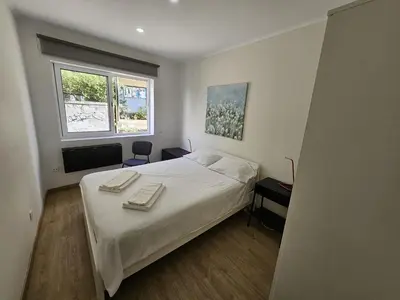 a bedroom with a bed with two towels on it at Apartamento Camões in Porto