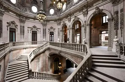 a large room with a staircase in a building at Apartamento Camões in Porto