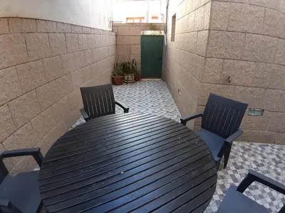 a black table and two chairs on a patio at Apartamento Camões in Porto