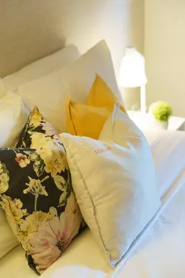 a bed with two pillows on it with a lamp at Stay in Apartments Ribeira 24 in Porto