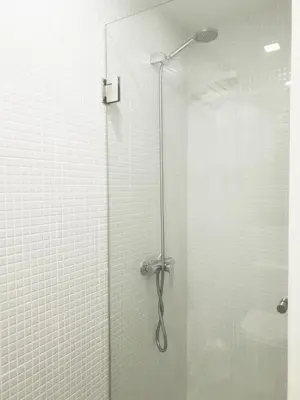 a shower with a glass door in a bathroom at Stay in Apartments Ribeira 24 in Porto