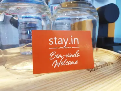 a sign that says stay inben whole melbourne on a table at Stay in Apartments Ribeira 24 in Porto