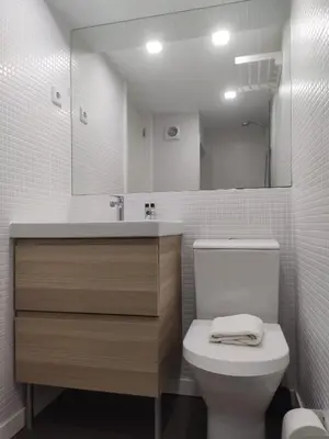 a bathroom with a toilet and a sink and a mirror at Stay in Apartments Ribeira 24 in Porto