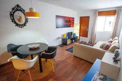 a living room with a table and chairs and a couch at Porto Downtown Flats in Porto