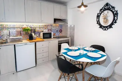 a kitchen with a table and chairs in a kitchen at Porto Downtown Flats in Porto