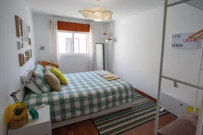 a small bedroom with a bed and a window at Porto Downtown Flats in Porto