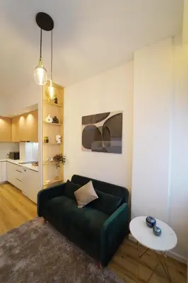 a living room with a green couch and a table at Crystal Palace Oporto Flat - With Two Bedrooms in Porto