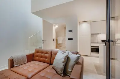 a remote control sitting on top of a leather couch at Minimalist Loft @ Terracotta Collection in Porto