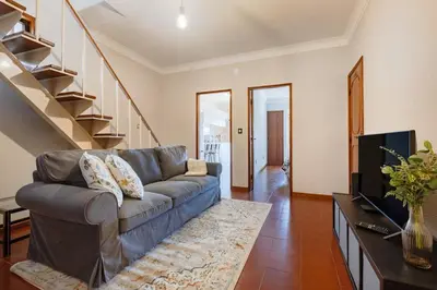 a living room with a couch and a staircase at Ildefonso Oporto Stay in Porto