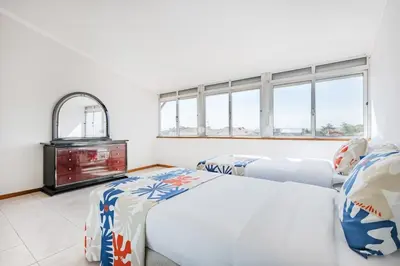 two beds in a room with colorful pillows at Ildefonso Oporto Stay in Porto