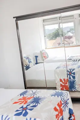 a bedroom with two beds and a mirror at Ildefonso Oporto Stay in Porto