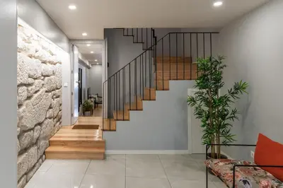 a staircase in a house with a stone wall at Porto Insight Apartments - Belomonte in Porto
