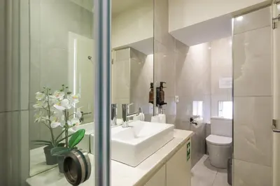 a white bathroom with a sink and a toilet at Porto Insight Apartments - Belomonte in Porto