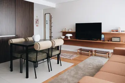 a living room with a table and chairs and a tv at Flair Living in Vila Nova de Gaia