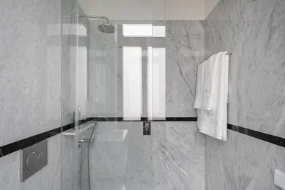 a bathroom with a shower and a glass shower at GuestReady - Elisium Star in Porto