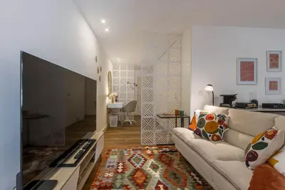 a living room with a couch and a television at OPO Ribeira I in Porto