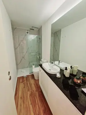 a bathroom with a sink and a toilet and a shower at OPO Ribeira I in Porto