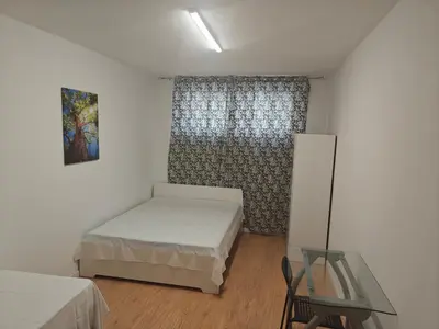 a small bedroom with a bed and a glass table at Ap Recanto do Pilar 5 min Ponte Luis in Vila Nova de Gaia