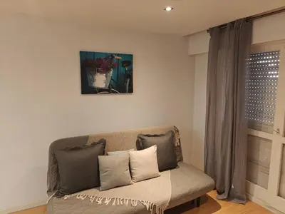 a couch in a living room with a picture on the wall at Ap Recanto do Pilar 5 min Ponte Luis in Vila Nova de Gaia