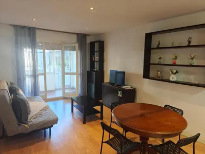 a living room with a table and a couch at Ap Recanto do Pilar 5 min Ponte Luis in Vila Nova de Gaia
