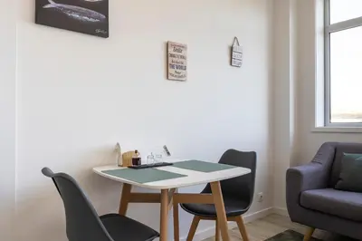 a small dining room with a table and chairs at ApartmentsPorto - Boavista Delight Studio in Porto