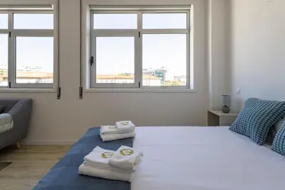 a bedroom with a bed with towels on it at ApartmentsPorto - Boavista Delight Studio in Porto